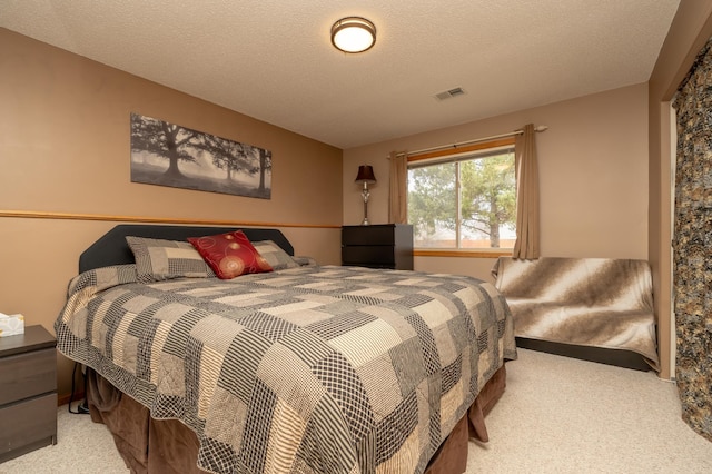 bedroom with carpet and a textured ceiling
