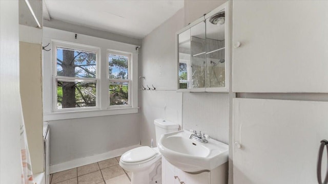 1001 Washington Memorial Dr, Saint Cloud, MN 56301 - full bathroom with toilet, tile patterned floors, vanity, baseboards, and a shower