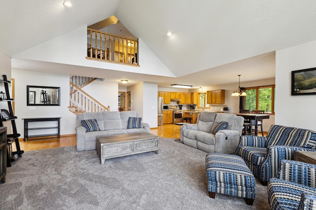 25306 Csah 4, Dassel Twp, MN 55325 - living room with light colored carpet, stairway, a chandelier, light wood-type flooring, and high vaulted ceiling