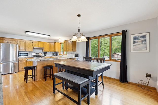 25306 Csah 4, Dassel Twp, MN 55325 - dining area with light wood finished floors, a chandelier, and baseboards