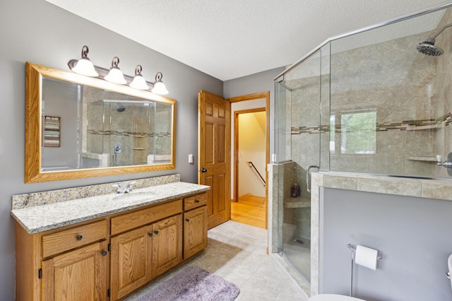 25306 Csah 4, Dassel Twp, MN 55325 - full bath featuring vanity, a shower stall, a textured ceiling, tile patterned flooring, and toilet