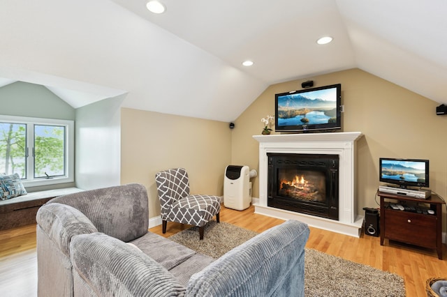 25306 Csah 4, Dassel Twp, MN 55325 - living room with vaulted ceiling, light wood-style flooring, a glass covered fireplace, and recessed lighting