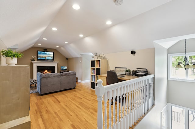 25306 Csah 4, Dassel Twp, MN 55325 - living area featuring lofted ceiling, light wood-style floors, recessed lighting, a warm lit fireplace, and baseboards