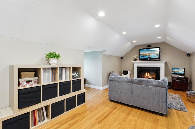 25306 Csah 4, Dassel Twp, MN 55325 - living room featuring wood finished floors, vaulted ceiling, a glass covered fireplace, baseboards, and recessed lighting