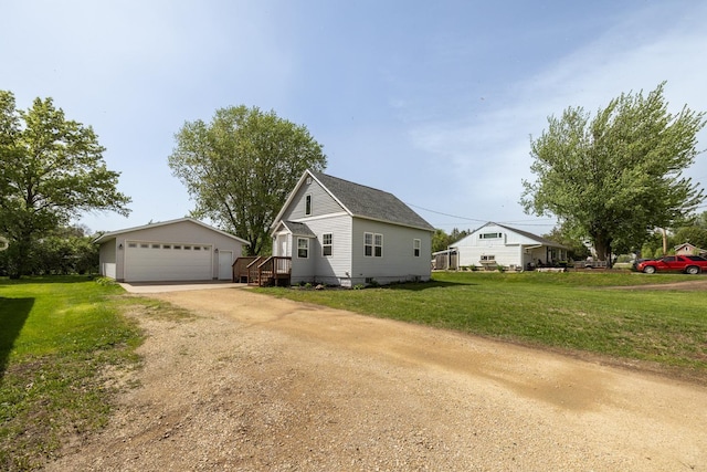 368 Main St, Zumbrota, MN 55992 - view of front of property featuring a garage, an outbuilding, and a front yard