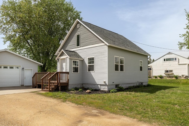 368 Main St, Zumbrota, MN 55992 - view of side of home featuring a shingled roof, a detached garage, and a lawn