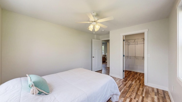 368 Main St, Zumbrota, MN 55992 - bedroom featuring a spacious closet, wood finished floors, baseboards, a closet, and ceiling fan
