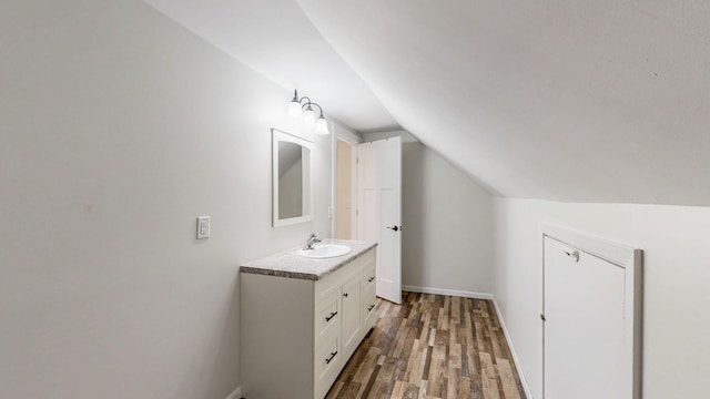 368 Main St, Zumbrota, MN 55992 - bathroom with vaulted ceiling, wood finished floors, vanity, and baseboards