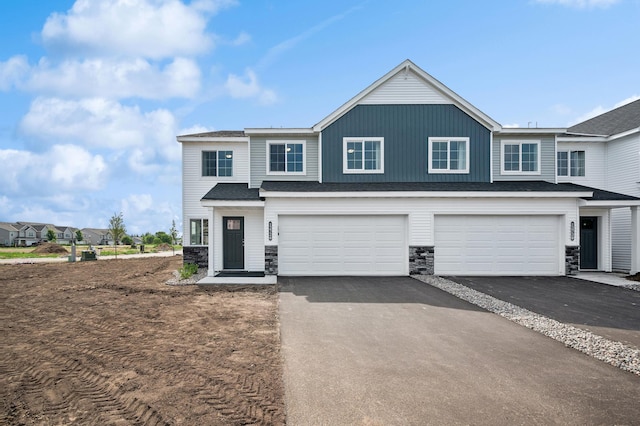 12726 8th Ave S, Zimmerman, MN 55398 - view of front of property with driveway, stone siding, and an attached garage
