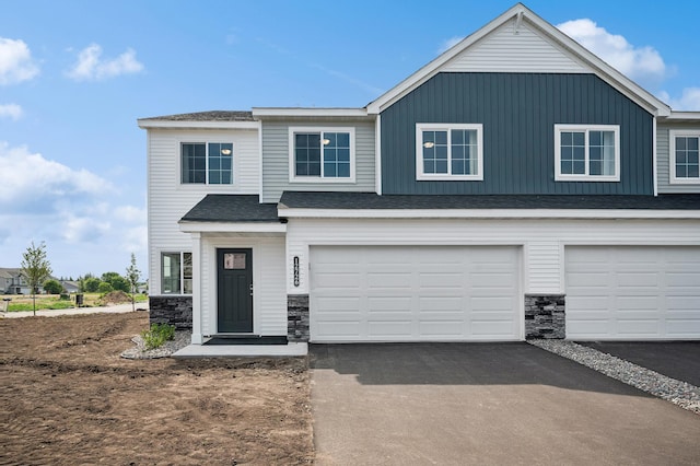 12726 8th Ave S, Zimmerman, MN 55398 - view of front of home with stone siding, driveway, and a garage