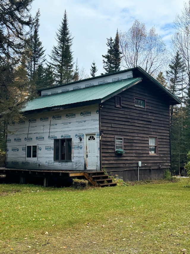 21 Brandon Ln, Grand Marais, MN 55604 - view of front facade with a front yard, entry steps, and metal roof