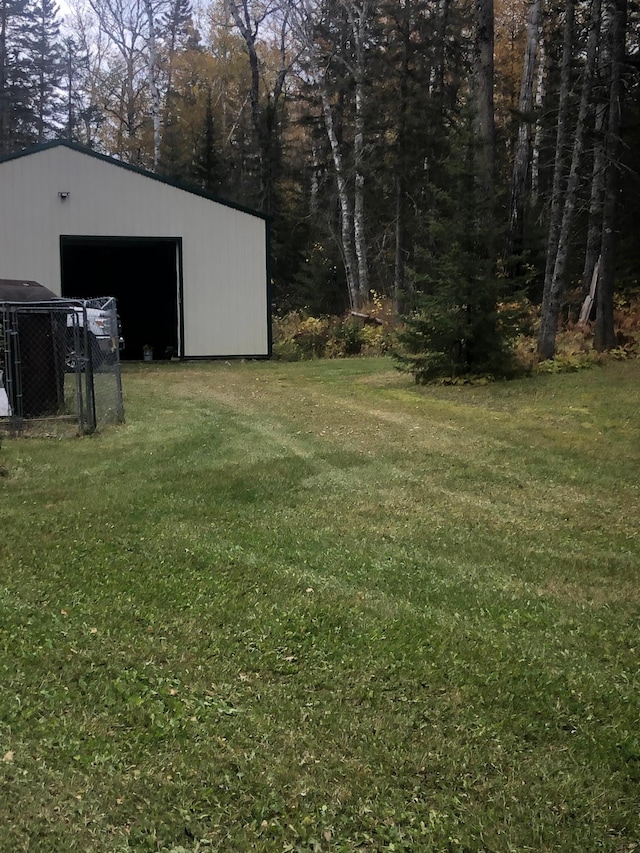 21 Brandon Ln, Grand Marais, MN 55604 - view of grassy yard featuring a detached garage and an outbuilding