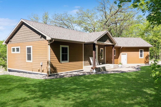 8259 Barton Ave NW, Buffalo, MN 55313 - rear view of house featuring a lawn, covered porch, and a shingled roof