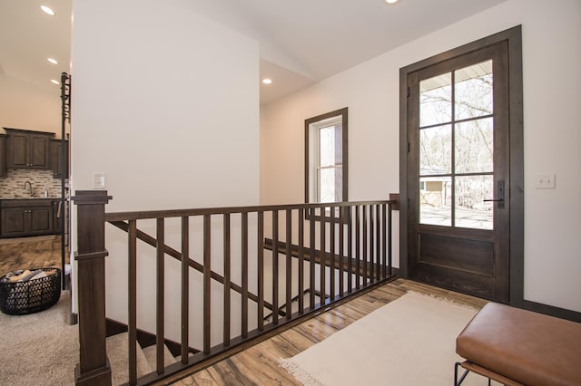 8259 Barton Ave NW, Buffalo, MN 55313 - entryway featuring wood finished floors, vaulted ceiling, and recessed lighting