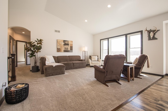 8259 Barton Ave NW, Buffalo, MN 55313 - living area with arched walkways, wood finished floors, recessed lighting, and high vaulted ceiling
