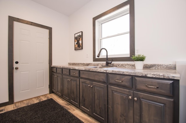 8259 Barton Ave NW, Buffalo, MN 55313 - laundry area with a sink and light wood finished floors
