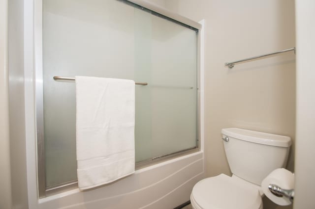 8259 Barton Ave NW, Buffalo, MN 55313 - bathroom with toilet and shower / bath combination with glass door