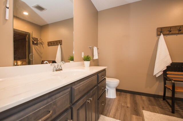 8259 Barton Ave NW, Buffalo, MN 55313 - bathroom with vanity, wood finished floors, and recessed lighting