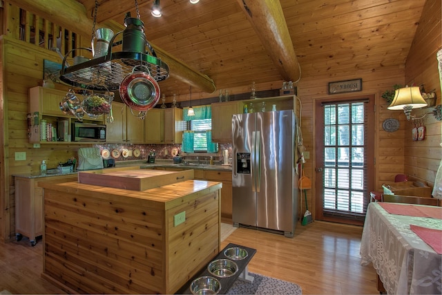 6000 152nd St, Milaca, MN 56353 - kitchen featuring appliances with stainless steel finishes, butcher block counters, wooden walls, light wood-style floors, and plenty of natural light
