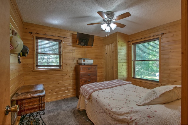 6000 152nd St, Milaca, MN 56353 - bedroom featuring multiple windows, carpet floors, wood walls, and a textured ceiling
