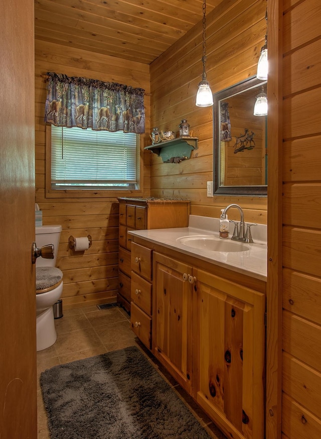 6000 152nd St, Milaca, MN 56353 - bathroom featuring toilet, wood walls, vanity, tile patterned floors, and wooden ceiling