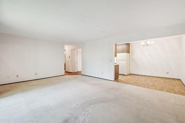 4360 Brookside Ct Unit 206, Edina, MN 55436 - unfurnished room with light colored carpet, a chandelier, and baseboards