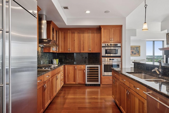 100 3rd Ave S Unit 3301, Minneapolis, MN 55401 - kitchen featuring stainless steel appliances, wine cooler, wall chimney exhaust hood, brown cabinets, and recessed lighting