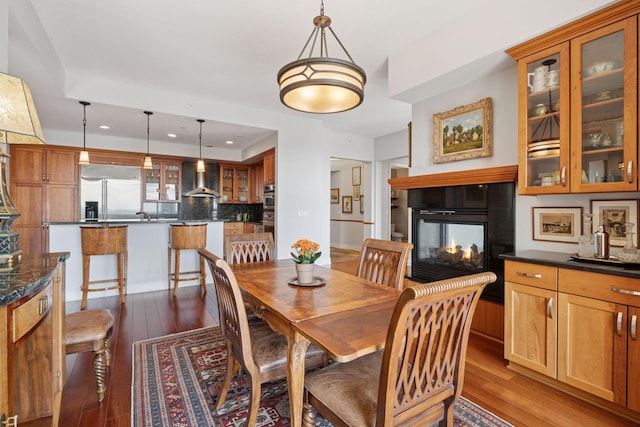 100 3rd Ave S Unit 3301, Minneapolis, MN 55401 - dining area featuring recessed lighting, a multi sided fireplace, dark wood-style floors, and baseboards