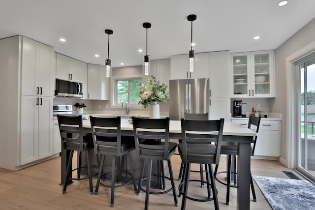 8466 Isleton Ct S, Cottage Grove, MN 55016 - kitchen featuring stainless steel appliances, white cabinetry, light countertops, and recessed lighting