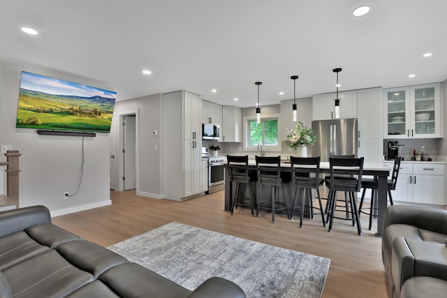 8466 Isleton Ct S, Cottage Grove, MN 55016 - living room featuring light wood finished floors, recessed lighting, and baseboards
