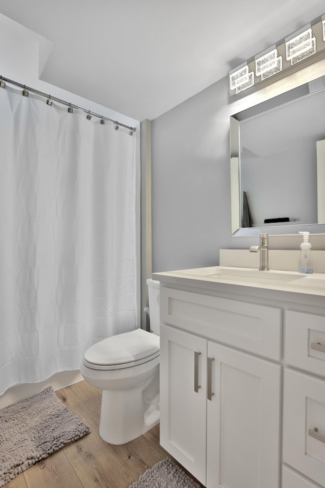 8466 Isleton Ct S, Cottage Grove, MN 55016 - bathroom featuring vanity, toilet, wood finished floors, and curtained shower