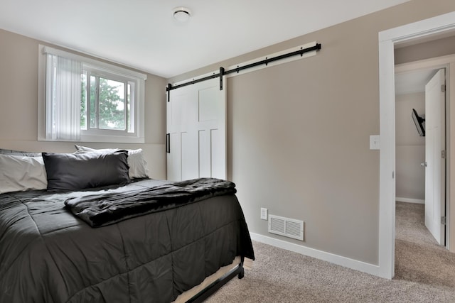 8466 Isleton Ct S, Cottage Grove, MN 55016 - bedroom with a barn door, carpet flooring, and baseboards