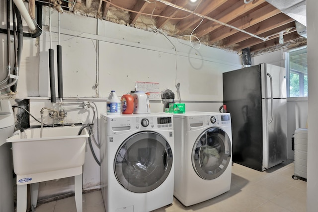 8466 Isleton Ct S, Cottage Grove, MN 55016 - laundry room with washing machine and dryer and light tile patterned floors