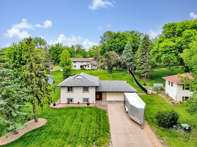 8466 Isleton Ct S, Cottage Grove, MN 55016 - back of house featuring a yard, brick siding, driveway, roof with shingles, and view of scattered trees