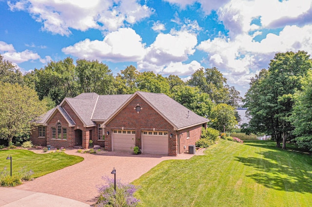8599 County Road 21 SW, Alexandria, MN 56308 - view of front facade featuring brick siding, a garage, a front lawn, driveway, and cooling unit