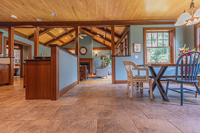 8599 County Road 21 SW, Alexandria, MN 56308 - unfurnished dining area with baseboards, wood ceiling, stone tile flooring, a chandelier, and a fireplace