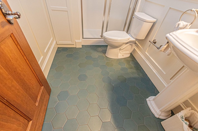 8599 County Road 21 SW, Alexandria, MN 56308 - bathroom featuring a decorative wall, tile patterned flooring, toilet, and a shower stall