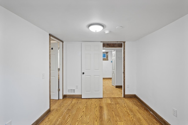unfurnished bedroom featuring light wood-style floors and baseboards