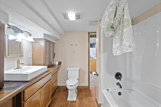 full bathroom featuring toilet,  shower combination, wood tiled floors, vanity, and baseboards