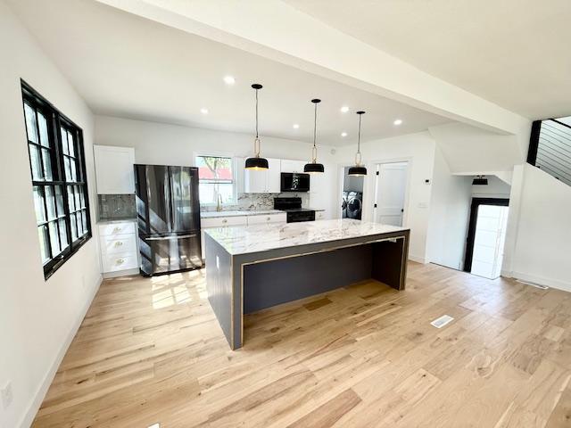 503 3rd St, Redwood Falls, MN 56283 - kitchen with black appliances, recessed lighting, a kitchen island, white cabinets, and light wood finished floors