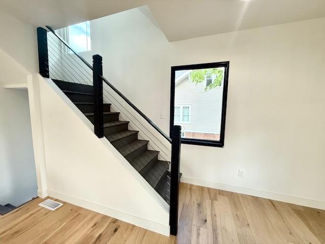 503 3rd St, Redwood Falls, MN 56283 - stairs featuring wood finished floors and baseboards