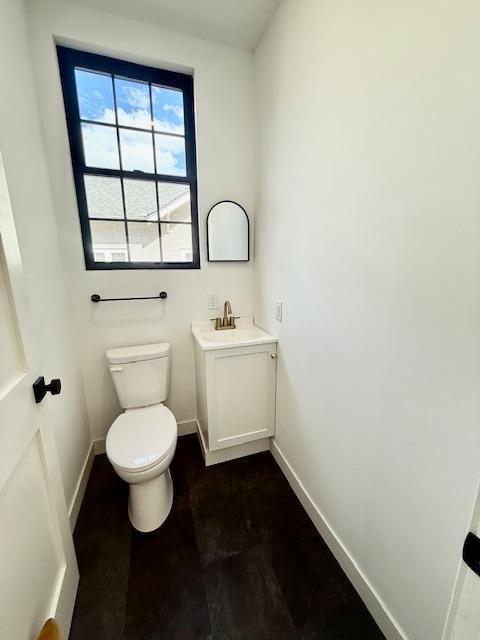 503 3rd St, Redwood Falls, MN 56283 - bathroom with baseboards, toilet, and vanity