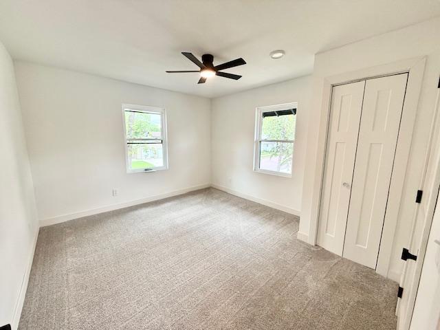503 3rd St, Redwood Falls, MN 56283 - unfurnished bedroom with multiple windows, carpet floors, a closet, and baseboards