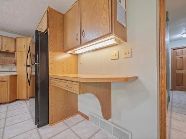 835 Winona Dr SW, Alexandria, MN 56308 - kitchen featuring freestanding refrigerator, a textured ceiling, light countertops, open shelves, and light tile patterned floors