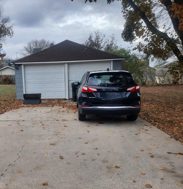 207 7th Ave S, Saint James, MN 56081 - view of side of property with a shingled roof, a detached garage, and an outdoor structure