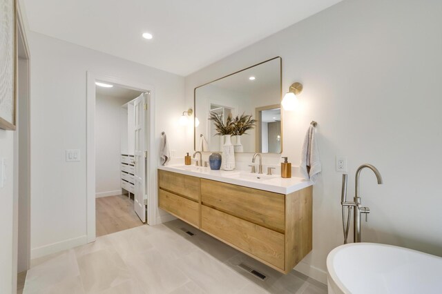 745 Virginia Shores Cir, Victoria, MN 55331 - full bathroom with double vanity, a freestanding tub, recessed lighting, and baseboards
