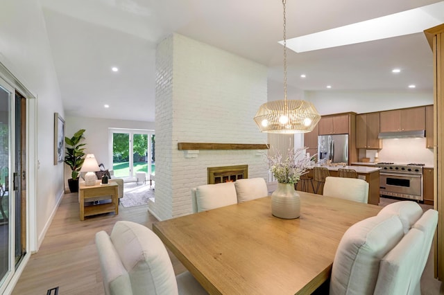 745 Virginia Shores Cir, Victoria, MN 55331 - dining room with light wood-style floors, a fireplace, a chandelier, high vaulted ceiling, and recessed lighting