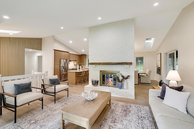 745 Virginia Shores Cir, Victoria, MN 55331 - living room featuring light wood finished floors, a brick fireplace, high vaulted ceiling, and recessed lighting