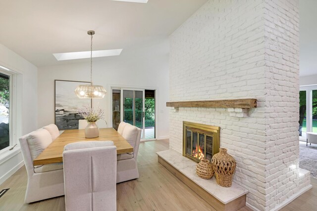 745 Virginia Shores Cir, Victoria, MN 55331 - dining area with a skylight, plenty of natural light, light wood finished floors, and vaulted ceiling