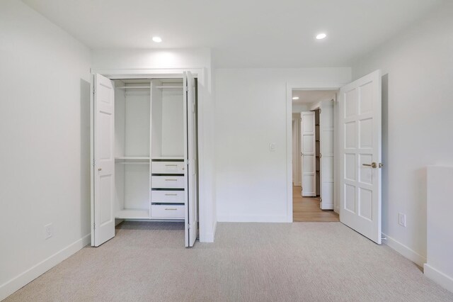 745 Virginia Shores Cir, Victoria, MN 55331 - unfurnished bedroom with light colored carpet, recessed lighting, baseboards, and a closet